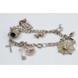 Silver charm bracelet, 26.2 grams with various charms.