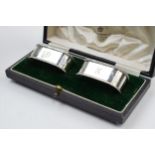 Cased silver Mappin and Webb pair of rectangular napkin rings, Birmingham 1923, with initials.