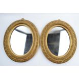 A pair of late 20th century reproduction gilt oval wall mirrors, 35cm long (2).