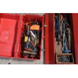 Vintage red metal folding toolbox with contents of various tools and equipment with a similar red