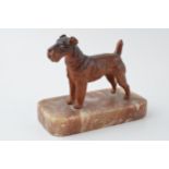 French Art Deco painted metal paperweight in the form of a terrier, 12cm long.