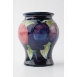 Early Moorcroft bulbous vase in the Wisteria pattern, 8.5cm tall. In good condition with no