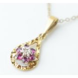 9ct gold pendant set with a diamond and amethysts on 9ct gold chain, 1.9 grams, chain length 41cm.