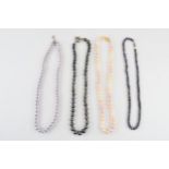 A collection of 4 faux pearl necklaces of varying colours (4).