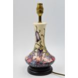 Moorcroft lamp in the Pasque pattern mounted onto wooden base, 31.5cm tall inc brass fittings.