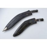 20th century Gurkha style Kukri knife in black leather scabbard together with smaller example (2),