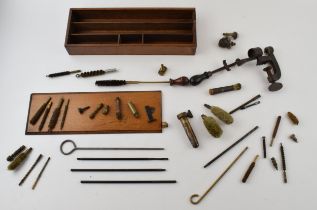 A collection of vintage gun cleaning and cartridge making accessories to include rods, brushes and