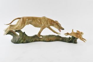 Elite Pottery hunting scene tableau in the form of lurcher chasing hare, length 48cm.