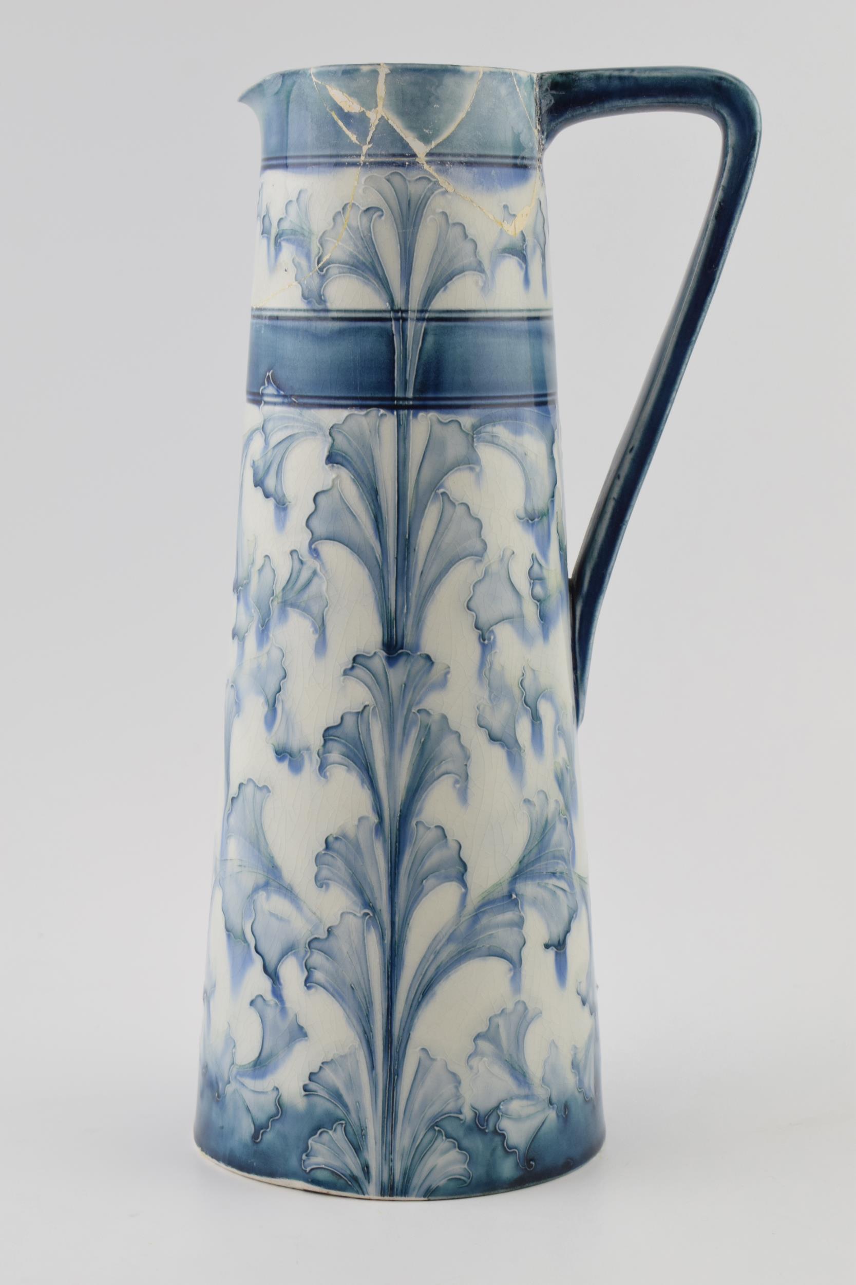 Early Moorcroft blue and white Florian pitcher, 28cm tall (restoration project).