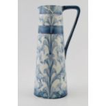 Early Moorcroft blue and white Florian pitcher, 28cm tall (restoration project).