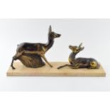 French Art Deco spelter figures of a pair of deers mounted on a marble base, 45cm long. Minor