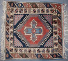 Vintage Turkish hand-knotted carpet with traditional pattern in reds, blues, creams and browns,