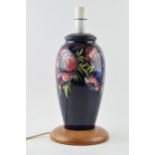 Moorcroft pottery lampbase in the Clematis (or similar) floral pattern on turned wooden base, 28cm