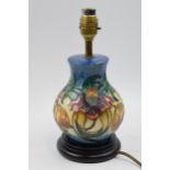 Moorcroft lamp in the Anna Lily pattern mounted onto wooden base, 27cm tall inc brass fittings. In