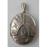 Victorian silver locket (front and back) with birds in flight to front, containing images.