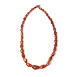 A graduated set of baltic amber (or similar) beads as a necklace with white metal clasp, circa 29