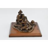 A contemporary bronzed composition model of a fireman and accident victim, 'Fallen Comrade' signed A