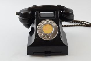 Vintage bakelite telephone and base, with wire.