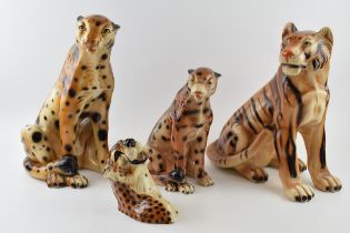 A collection of large Italian style cast figures of Cheetahs of varying sizes with a wall plaque (