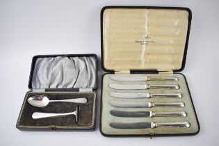 A cased christening set to include a spoon and pusher, Birmingham 1921, 39.3 grams, with a set of