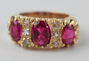 9ct gold dress ring with 3 bright pink stones with 6 smaller clear stones, 7.2 grams, size K.