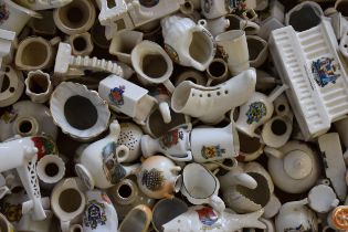 A collection of crested china items to include animals, jugs, vases and varying forms and decoration