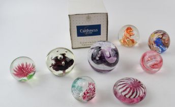 A collection of glass paperweights to include a boxed example by Caithness, Scotland. (8) In good