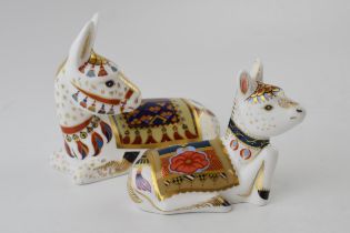 Two Royal Crown Derby paperweights, Donkey and Donkey Foal, both with red printed marks on the base,