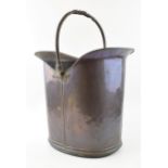 Arts and Crafts Movement coal scuttle in copper. wrought iron handle with decorative twist. Height