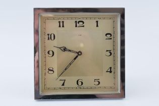 Square Art Deco clock with 8 day mechanical winding movement and chrome surround. Winds, runs and