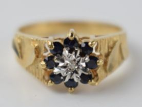 9ct gold sapphire and illusion set diamond floral ring, 3.1 grams, size O.