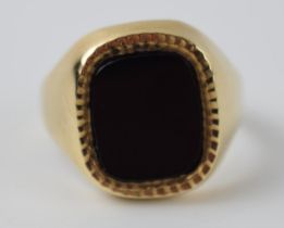 9ct gold and onyx gents ring with bright cut edge, 7.2 grams, size V.