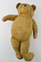 Early to mid 20th century teddy bear with glass eyes and voice box (non working), 45cm long.