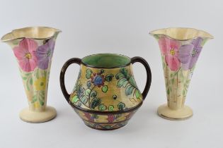 A pair of Arthur Woods floral shaped trumpet vases and a large two handled floral vase, believed