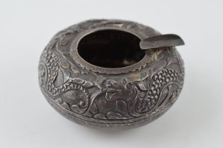 Eastern silver ornate ashtray with dragon design, markings to underside, 31.1 grams. Some dents