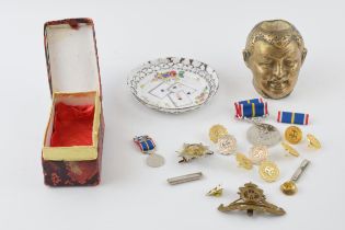 A collection of military medals and badges together with a match holder and strike and a enamelled