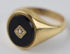 9ct gold and onyx ring set with diamond, 5.1 grams, size V.