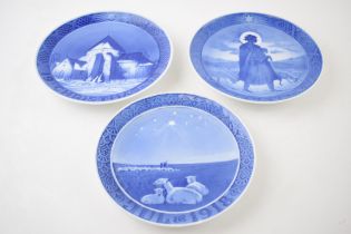 A trio of Royal Copenhagen Christmas plates to include 1957, 1918 (chipped) and 1938 (3). 2 are in