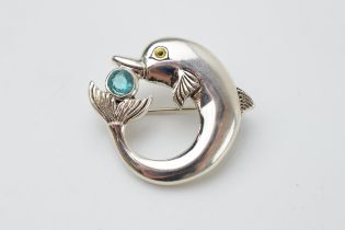 Sterling silver brooch in the form of a dolphin with gemstone, in a Danish style, 36mm wide.