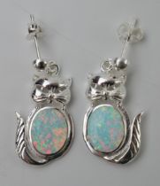 A pair of sterling silver earrings in the form of cats with opal style inserts (2).