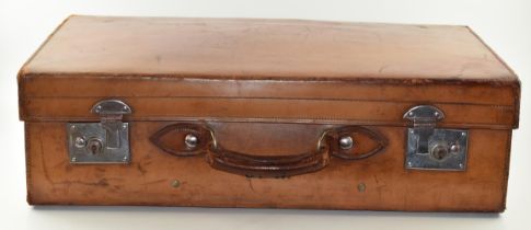 An early 20th century Fortnum and Mason 'Cruzer' leather suitcase with metal fixings and leather