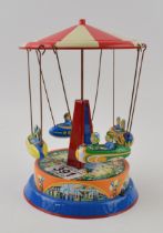 Tinplate mechanical roundabout 'Spaceships Ride' . Height 19cm. In working order