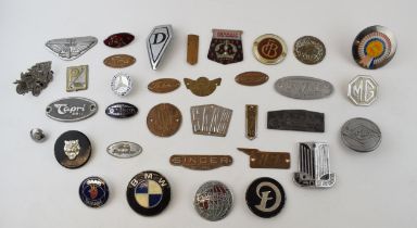 A quantity of vintage car and car club badges to include brass and chromed badges by