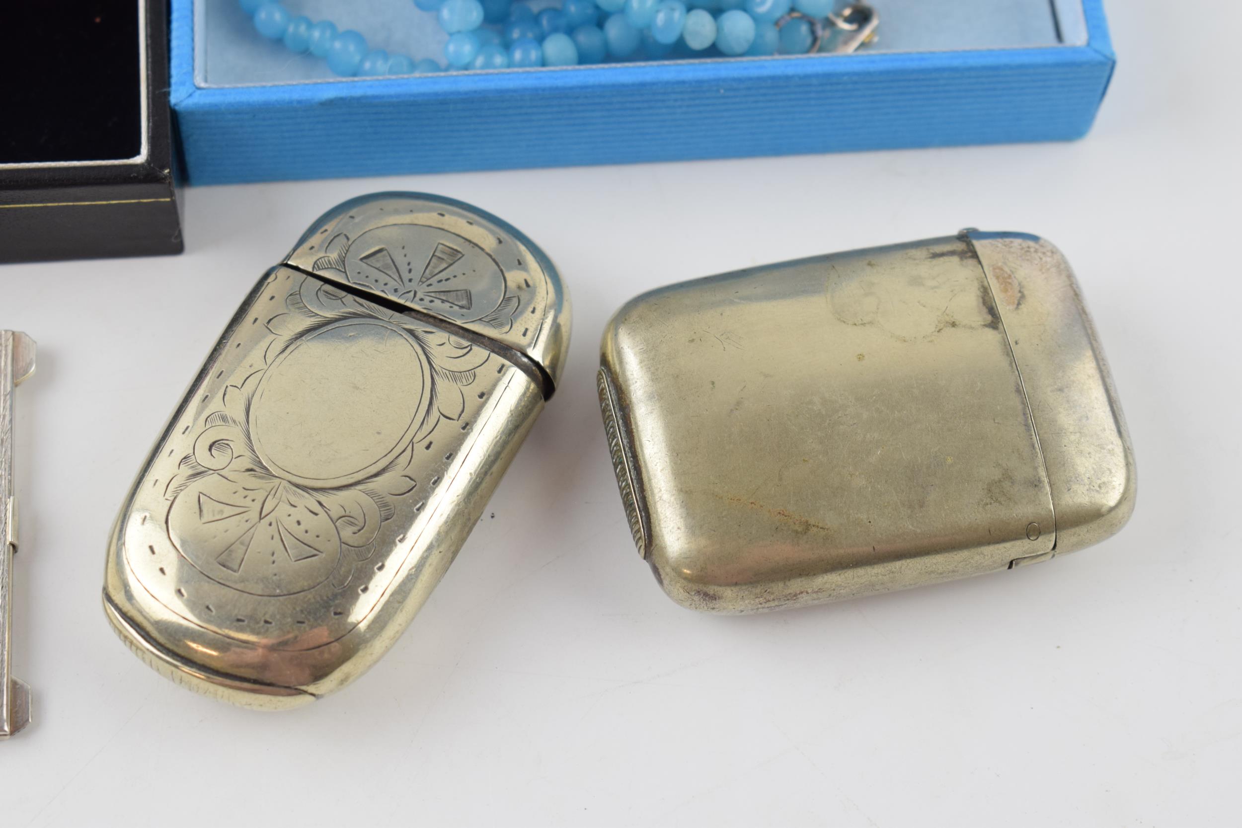 A collection of items to include a silver 800 stamp case, plated vesta cases, a white metal - Image 2 of 4