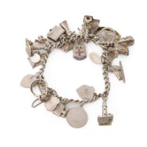 Silver charm bracelet with various charms to include an ice skating boot, rings, a lighthouse and