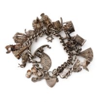 Silver charm bracelet with various charms to include a tankard, a fan, a crab, a bull and others,