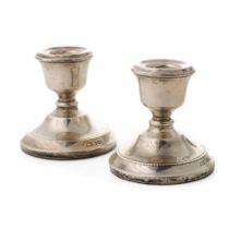 Hallmarked silver candlesticks, Sheffield, 'ATC', loaded bases, 7cm tall (2).