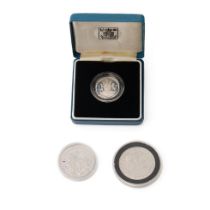 A collection of silver proof coins to include boxed 1983 Royal Mint £1 coin, The Legend of St George