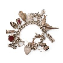 Silver charm bracelet with various charms to include an aeroplane, a tram, a robot, a miner's lamp
