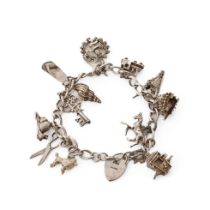 Silver charm bracelet with various charms to include a poodle, a hedgehog, a shell, a carriage and